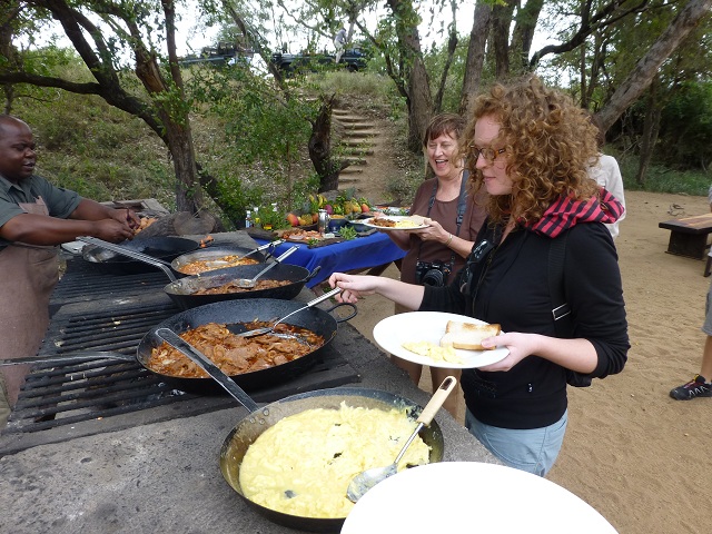 Marnie and Brianna serve themselves directly from the fry pans (as does everyone else).  Photo by FG.