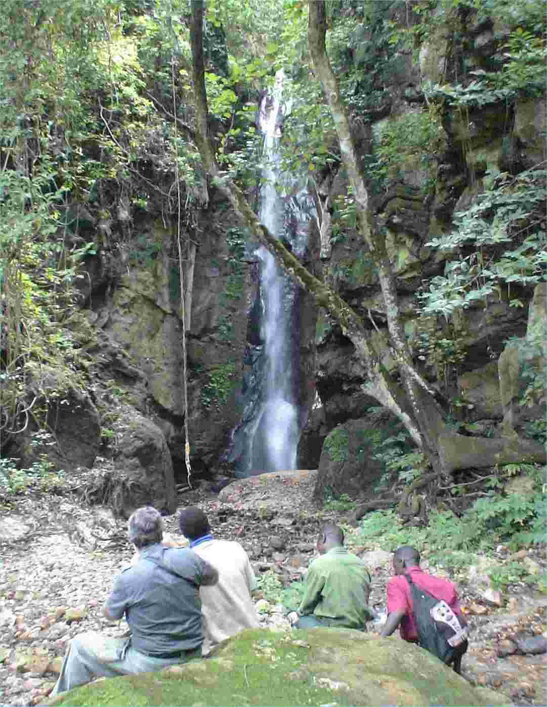 JJ and our guides view Kakombe Waterfall.  Photo by FG, Dec. 2005.